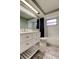 Well-lit bathroom featuring a white vanity, a large mirror, and subway tile, creating a clean and modern aesthetic at 9120 Lunar Ln, Port Richey, FL 34668