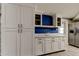 Contemporary kitchen showcasing white cabinets, stainless steel appliances, and tile flooring, providing a modern cooking experience at 9120 Lunar Ln, Port Richey, FL 34668