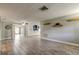 Open-concept living room featuring neutral walls, modern tile flooring, and abundant natural light, creating a bright and airy space at 9120 Lunar Ln, Port Richey, FL 34668