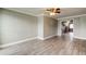 Spacious living area featuring tile floors, a ceiling fan, and an open layout leading to other rooms, maximizing space and flow at 9120 Lunar Ln, Port Richey, FL 34668