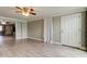 Bright living room with tile flooring, neutral walls, and an open doorway, creating a seamless transition to the rest of the home at 9120 Lunar Ln, Port Richey, FL 34668