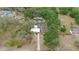 Aerial view of the property featuring a screened-in pool area and ample green space at 9615 Jasmine Blvd, New Port Richey, FL 34654