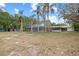 A screened pool is centered in the yard, with mature trees surrounding the property at 9615 Jasmine Blvd, New Port Richey, FL 34654