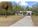 Charming single-story home featuring mature palm trees and a well-maintained front lawn at 9615 Jasmine Blvd, New Port Richey, FL 34654