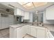 Functional kitchen with white cabinetry and appliances, creating a clean and efficient workspace at 9615 Jasmine Blvd, New Port Richey, FL 34654