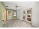 Living room features tiled floors, white trim, with rear door and glass sliding doors at 9615 Jasmine Blvd, New Port Richey, FL 34654