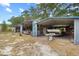 Exterior shot of the carports, featuring a boat and other supplies at 9615 Jasmine Blvd, New Port Richey, FL 34654