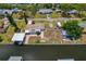 Waterfront home featuring a boat lift, brick patio, and well-maintained landscaping at 103 W North Branch Rd, Ruskin, FL 33570