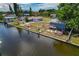 Aerial view of the waterfront property including canal, boatlifts, shed, and landscaping at 103 W North Branch Rd, Ruskin, FL 33570