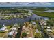 Waterfront home on canal highlighted in aerial view among the community of similar homes at 103 W North Branch Rd, Ruskin, FL 33570