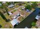 Waterfront home with RV parking, dock, and boat lift, surrounded by mature landscaping at 103 W North Branch Rd, Ruskin, FL 33570