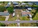 Aerial view of a property showcasing the home's positioning along canal and proximity to neighborhood amenities at 103 W North Branch Rd, Ruskin, FL 33570