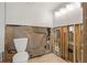 Bathroom featuring a toilet and exposed framing at 103 W North Branch Rd, Ruskin, FL 33570