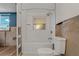 Newly tiled tub and shower with modern fixtures and a window at 103 W North Branch Rd, Ruskin, FL 33570