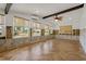 Living room featuring cathedral ceilings, beams, fan, and light-colored hardwood flooring at 103 W North Branch Rd, Ruskin, FL 33570
