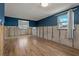 Remodeled living room showcasing new wood flooring, blue accent wall, and natural light at 103 W North Branch Rd, Ruskin, FL 33570