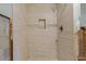 Walk-in shower featuring modern tile, a niche, and pebble floor at 103 W North Branch Rd, Ruskin, FL 33570