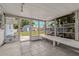 The sun room has tile flooring, multiple windows, and a bench at 103 W North Branch Rd, Ruskin, FL 33570