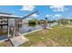 Waterfront view of the property featuring a boat lift, canal, and lush landscaping at 103 W North Branch Rd, Ruskin, FL 33570