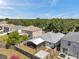 Aerial view of fenced backyard with screened lanai, concrete patio, and lush tree line at 10431 Frog Pond Dr, Riverview, FL 33569