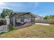 Backyard featuring a screened lanai with brick accent, concrete patio, and fenced yard at 10431 Frog Pond Dr, Riverview, FL 33569