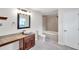 Bathroom featuring granite counters, vessel sink, tub, and a shower at 10431 Frog Pond Dr, Riverview, FL 33569