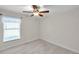Bedroom with ceiling fan and large window at 10431 Frog Pond Dr, Riverview, FL 33569