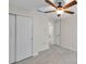 Bedroom featuring a ceiling fan, closet, and bathroom access at 10431 Frog Pond Dr, Riverview, FL 33569