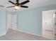 Bedroom featuring a ceiling fan and two access doors at 10431 Frog Pond Dr, Riverview, FL 33569