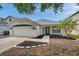 Charming single-story home featuring a well-maintained lawn and inviting front entrance at 10431 Frog Pond Dr, Riverview, FL 33569