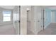 Bright hallway with tile floors leading to various rooms with white doors at 10431 Frog Pond Dr, Riverview, FL 33569