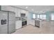 Modern kitchen featuring stainless steel appliances, white cabinetry and an open design at 10431 Frog Pond Dr, Riverview, FL 33569