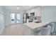 Bright kitchen with stainless steel appliances, white cabinetry and a breakfast bar at 10431 Frog Pond Dr, Riverview, FL 33569