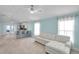 Living room featuring light walls, wood flooring, white sectional sofa, and an open floor plan at 10431 Frog Pond Dr, Riverview, FL 33569
