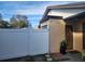Welcoming front entrance with a wooden door, a fenced yard, and a touch of greenery at 10539 Parkcrest Dr, Tampa, FL 33624