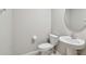 Neat half bathroom with a pedestal sink and toilet providing a clean and functional space at 10822 Crushed Grape Dr, Riverview, FL 33578