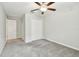 Bedroom features plush carpet, ceiling fan, and a double-door closet for ample storage at 10822 Crushed Grape Dr, Riverview, FL 33578