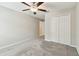 Bedroom features plush carpet, ceiling fan, and a double-door closet for ample storage at 10822 Crushed Grape Dr, Riverview, FL 33578