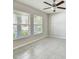 Bedroom boasting natural light from large windows and a ceiling fan, creating a comfortable space at 10822 Crushed Grape Dr, Riverview, FL 33578