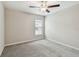Bright bedroom with soft carpet, ceiling fan, and a window that offers natural light at 10822 Crushed Grape Dr, Riverview, FL 33578