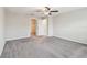 Spacious bedroom with a ceiling fan, carpeted floors and open closet entrance at 10822 Crushed Grape Dr, Riverview, FL 33578
