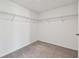 Walk-in closet with carpeted floor and ample shelving for storage and organization at 10822 Crushed Grape Dr, Riverview, FL 33578