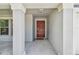 Covered front porch with a view to the front door at 10822 Crushed Grape Dr, Riverview, FL 33578