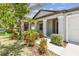 Charming single-story home featuring a covered entryway and colorful landscaping at 10822 Crushed Grape Dr, Riverview, FL 33578