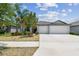 Charming single-story home featuring a spacious driveway and well-maintained landscaping at 10822 Crushed Grape Dr, Riverview, FL 33578