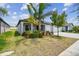 Well-maintained single-story home featuring a spacious driveway, lawn, and landscaping at 10822 Crushed Grape Dr, Riverview, FL 33578