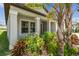 Charming single-story home featuring a covered entryway and colorful landscaping at 10822 Crushed Grape Dr, Riverview, FL 33578