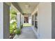 Covered front porch with pillars and view to the yard at 10822 Crushed Grape Dr, Riverview, FL 33578