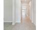 Bright hallway with tiled flooring leads to other rooms, offering a seamless flow at 10822 Crushed Grape Dr, Riverview, FL 33578