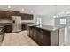 Open kitchen featuring stainless steel appliances, granite countertops, and a spacious island at 10822 Crushed Grape Dr, Riverview, FL 33578